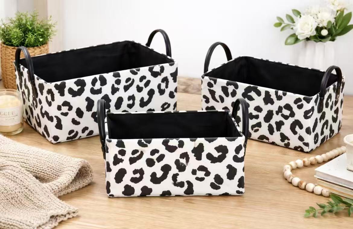 Three-piece zebra and cow print storage baskets with handles for home organization.