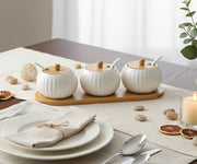 Seven piece porcelain kitchen canister set with matching bamboo tray for organized countertop storage