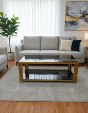 Black tempered-glass coffee table with gold steel frame.