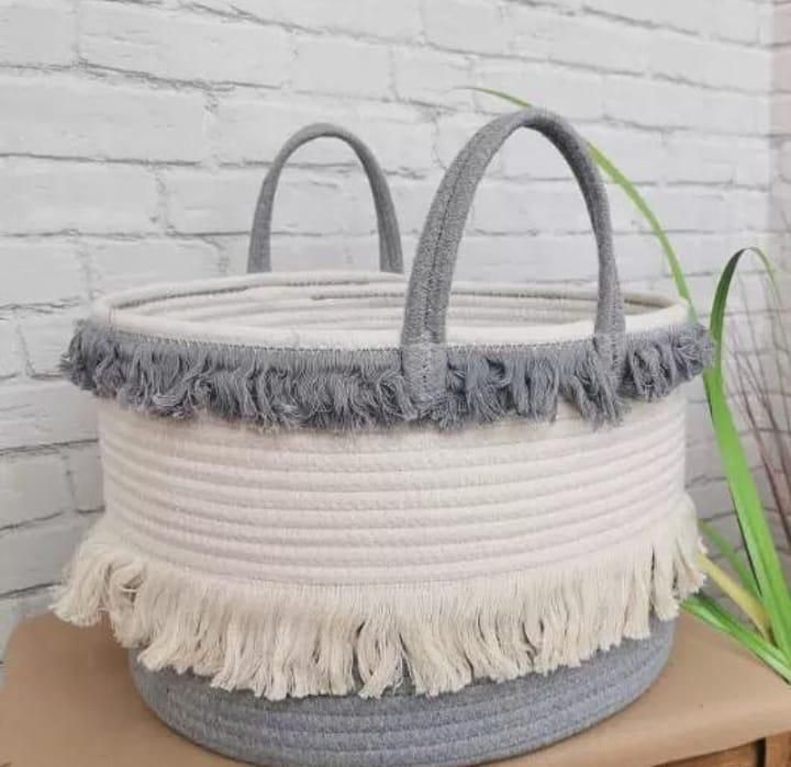 Decorative woven storage basket suitable for toys, throws, or laundry with wide mid diameter design