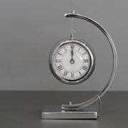 Dawood Lifestyle & Gadgets kes silver hanging tabletop quartz clock with polished chrome arch stand, Roman numeral dial, and modern executive desk design.