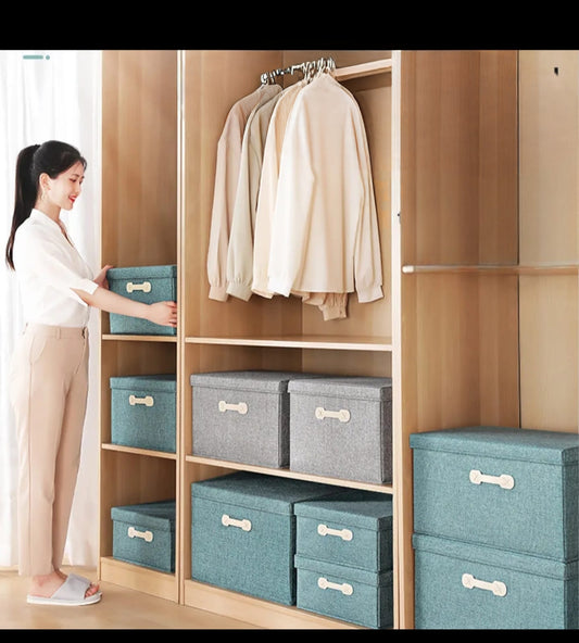 Set of two foldable multi-purpose linen storage boxes in two sizes.