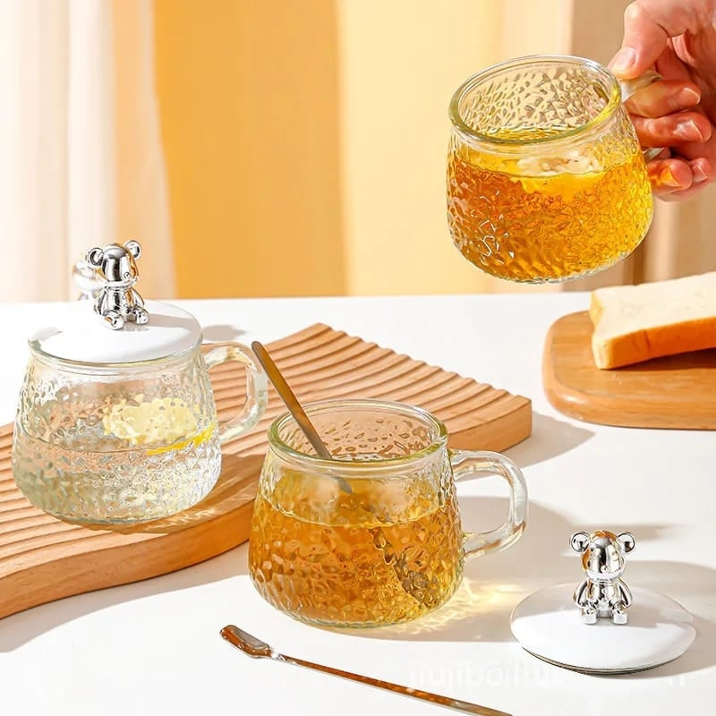 250ml Borosilicate glass cup with lid and spoon suitable for beverages or sugar storage.
