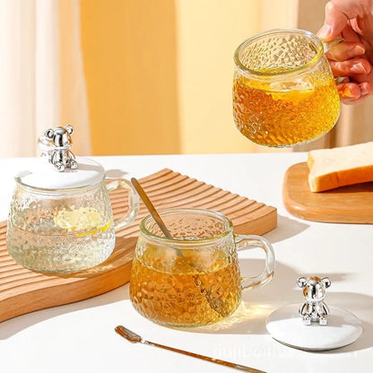 250ml Borosilicate glass cup with lid and spoon suitable for beverages or sugar storage.