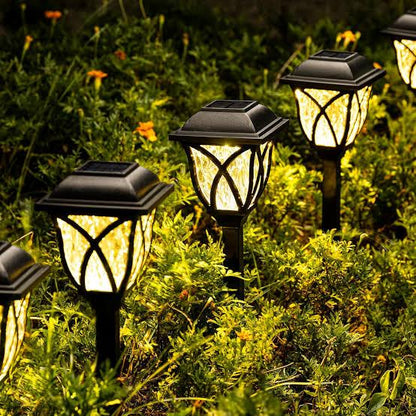 Classic solar pathway lights in coach lantern style with matte black finish, warm LED glow and decorative outdoor lighting