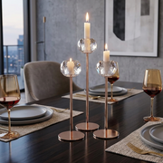 Set of three metallic candle holders in black, gold, and silver for elegant home décor