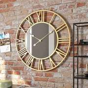 Luxury gold metal wall clock with mirror accents, Roman numerals, and silent movement measuring 50 cm in diameter.