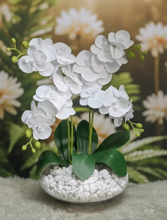 Glass vase with artificial orchid flowers displayed for home décor