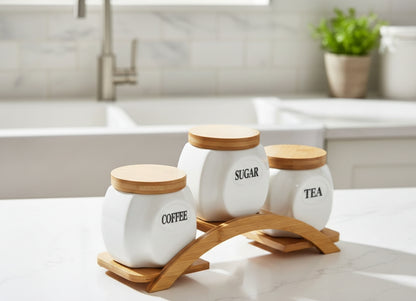Three round kitchen canisters on a bamboo base.