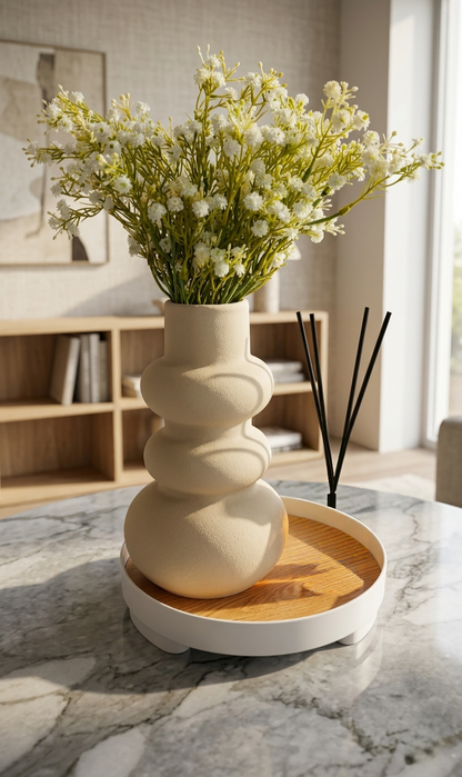 Decorative vase with tray and artificial flowers arranged for modern home décor styling