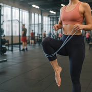 Spring exerciser stretch band with sturdy spring and grip handles.