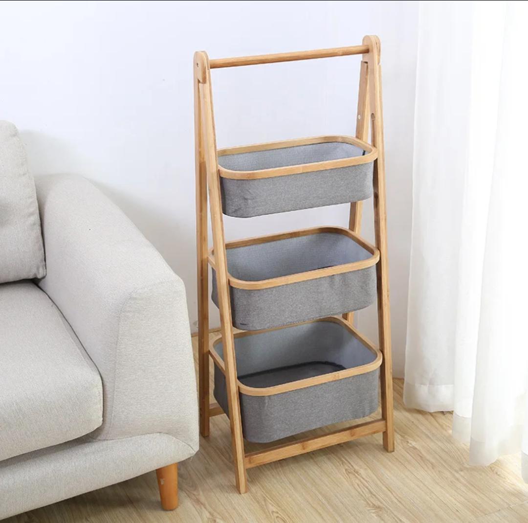 Foldable bamboo laundry hamper with pull-out fabric baskets and top shelf for organized storage