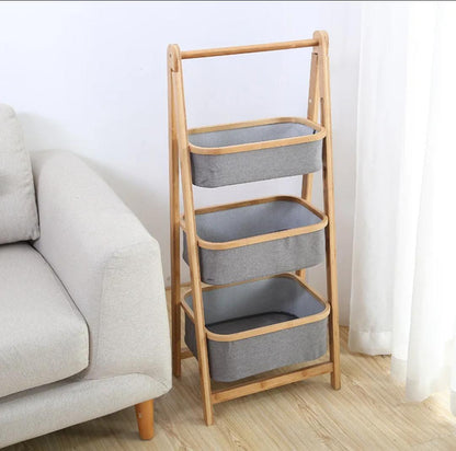 Foldable bamboo laundry hamper with pull-out fabric baskets and top shelf for organized storage