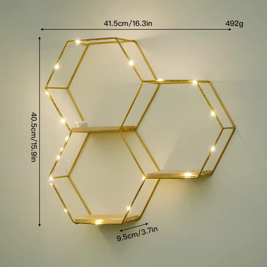 Dawood Lifestyle & Gadgets kes 3-piece gold hexagon floating wall shelf with natural wood bases and warm LED fairy lights in a geometric honeycomb design.