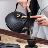 Cast iron tea pot with infuser, cast iron coaster and spoon