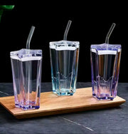 Pentagonal heavy-duty glass tumbler with straw, 380ml capacity, in assorted shades.