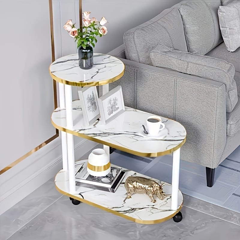 Three layer trolley rack table with oval round top design in black and white marble finish measuring 60×30×67 cm.