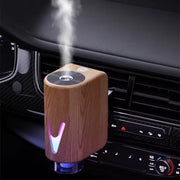 Smart magnetic car diffuser with ambient LED lighting and essential oil bottles for refreshing vehicle fragrance.
