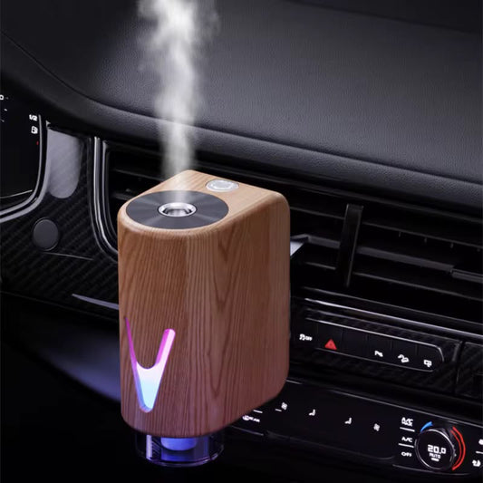Smart magnetic car diffuser with ambient LED lighting and essential oil bottles for refreshing vehicle fragrance.