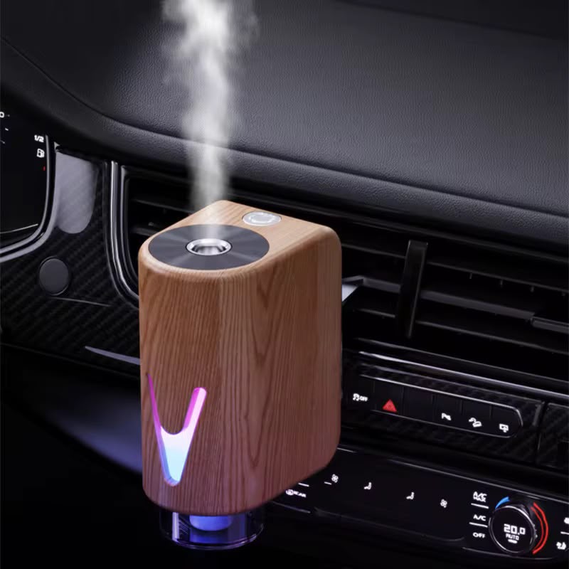 Smart magnetic car diffuser with ambient LED lighting and essential oil bottles for refreshing vehicle fragrance.
