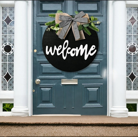 Black round decorative welcome wall hanging with 30cm diameter.