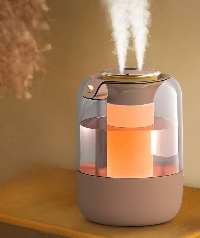 White 2.2L humidifier with dual mist outlets and flame-effect lighting.