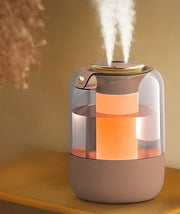 White 2.2L humidifier with dual mist outlets and flame-effect lighting.
