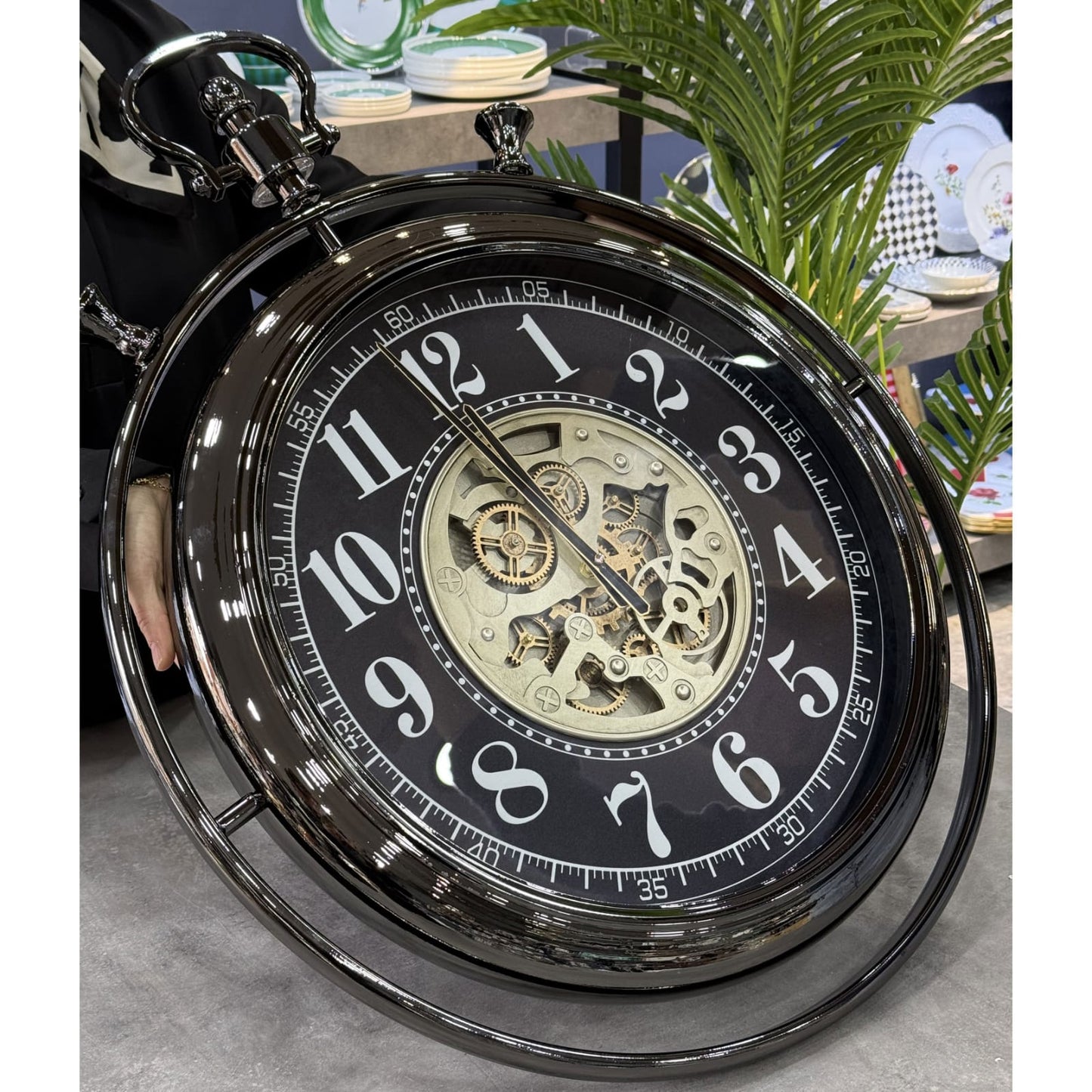 Metallic vintage style wall clock with decorative moving gears and industrial-inspired design. 🕰️