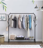 Single pole standing clothes drying rack with shoe shelf, side hooks, and wheels.