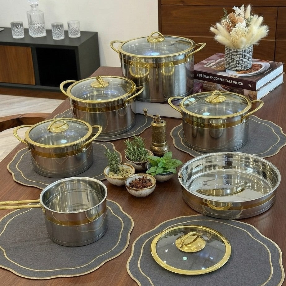 11 piece stainless steel cookware set with tempered glass lids and gold trim, featuring casseroles from 1.6 L to 7 L.