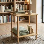 Brown wooden multifunctional bedside table with storage shelf for bedroom and living room use. 