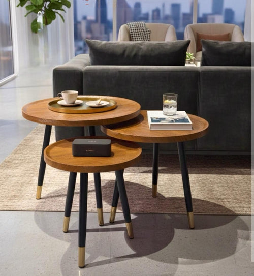 3 Piece hexagonal nesting table set with water-resistant MDF tops, black metal legs, and gold-accented feet for modern home décor