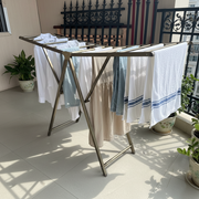 Vertical ladder style drying rack for clothes featuring a space-efficient design suitable for indoor and outdoor laundry use.