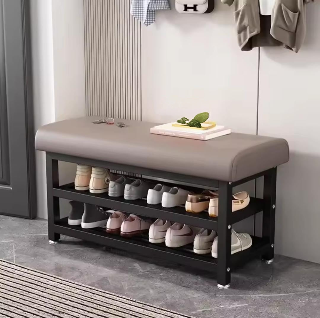 Entryway shoe rack with metallic base and padded seat.