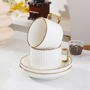 European style ceramic coffee and tea cup set with gold edge and striped design including cups and saucers