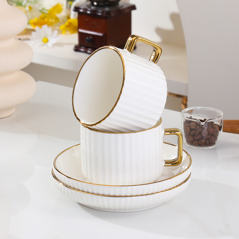 European style ceramic coffee and tea cup set with gold edge and striped design including cups and saucers