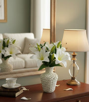 Artificial tiger lily flowers arranged in a plastic vase