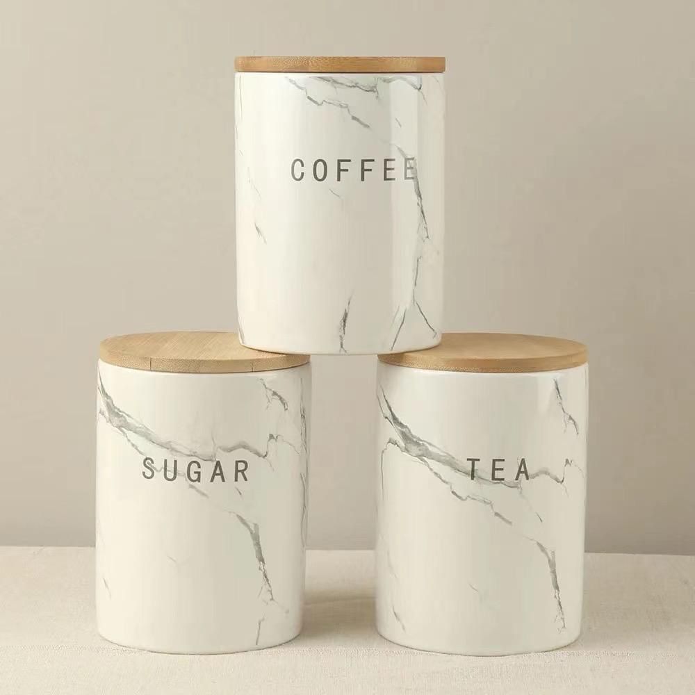 Three piece ceramic kitchen canisters with bamboo lids