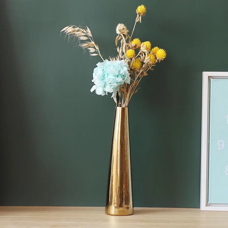 Plain gold ceramic vase with a small narrow neck used for decorative floral arrangements in modern home décor ✨