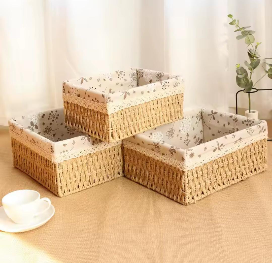 Set of three beige handwoven rattan storage baskets arranged together