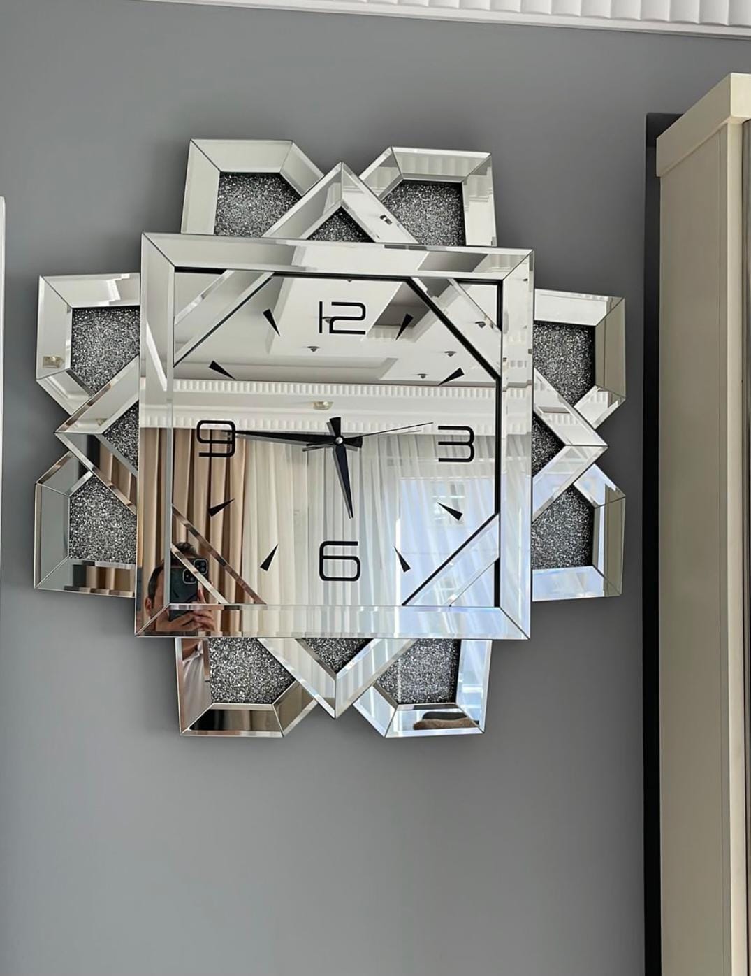Luxury mirrored wall clock with crystal accents designed as a decorative and functional home décor piece. 
