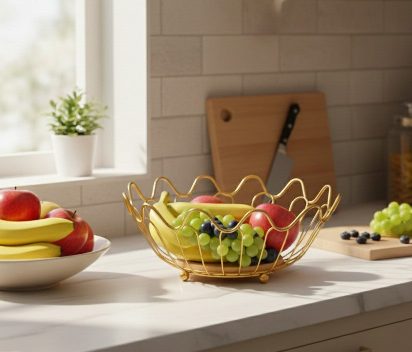Gold metal fruit basket with sturdy wooden base for kitchen or table display