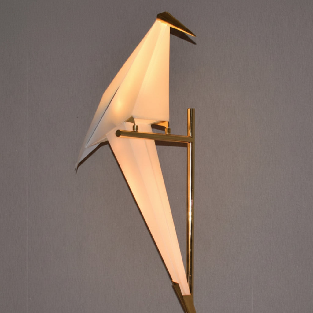 Dawood Lifestyle & Gadgets kes geometric origami bird floor lamp featuring a glowing white acrylic bird mounted on a polished gold stand, modern sculptural LED lighting for living rooms, bedrooms, hotels, offices, and luxury interiors.
