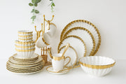 44 piece shell dinner set with plates, bowls, cups, saucers, tea spoons, platter, and serving bowl for elegant dining.