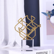 Gold geometric knot statue with crystal base, modern decorative sculpture for home and office décor.