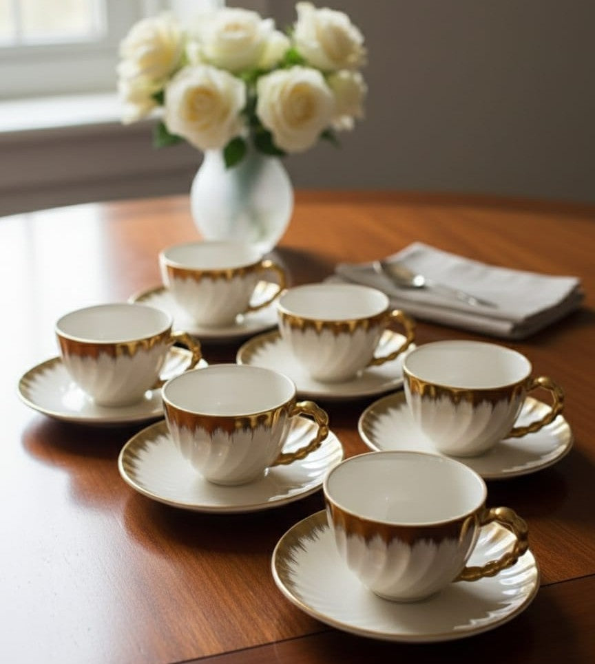 Ceramic cup and saucer shell set in white with gold detailing, 6 cups and 6 saucers