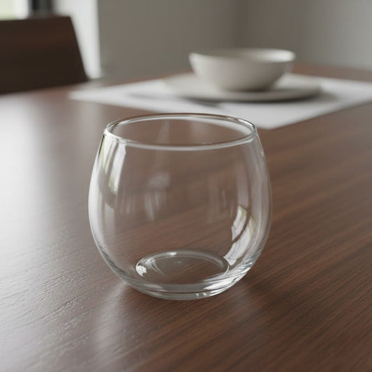 Clear round stemless wine glass made of glass.