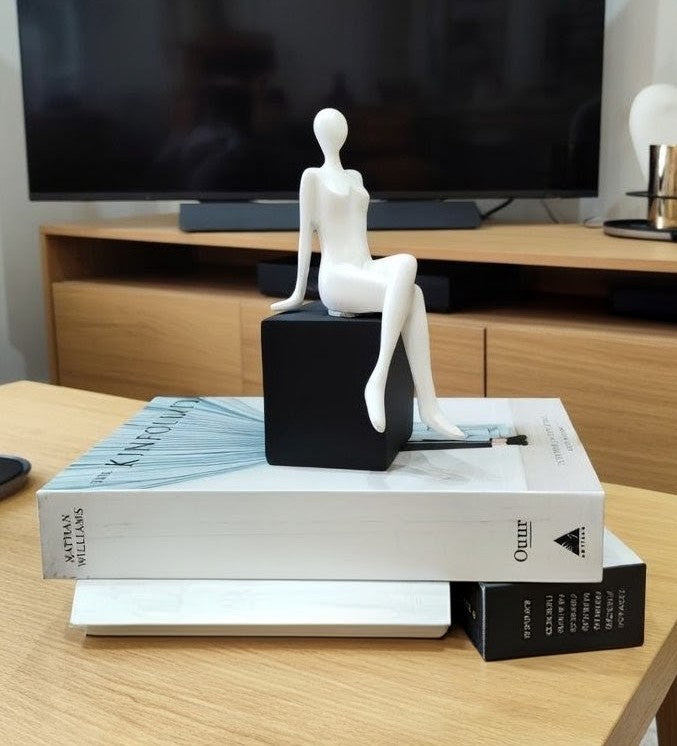 Handmade sitting girl resin figurine, elegant decorative sculpture for home or office display.