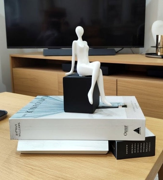 Handmade sitting girl resin figurine, elegant decorative sculpture for home or office display.