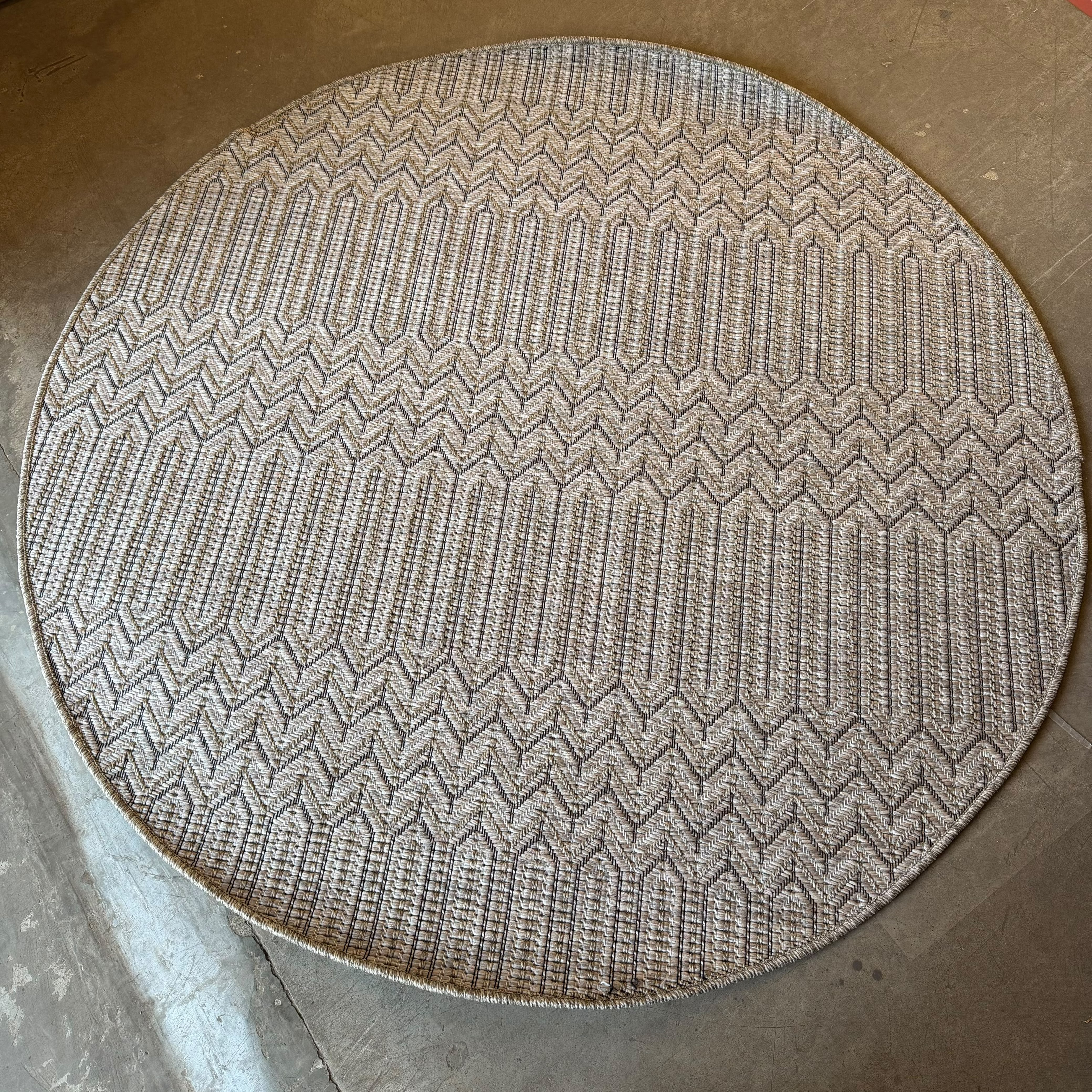 Oriental Weavers Oria round chevron flat weave rug in beige, taupe, and black polypropylene with geometric pattern.